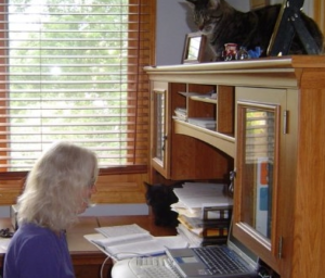 When I went to find a picture of me at my desk, my true secret popped out: It helps to have two cats for company!